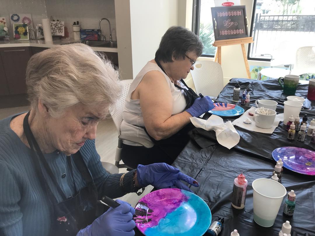 Elderly Woman Painting Pottery. Photo by Instagram user @artcellarhouston