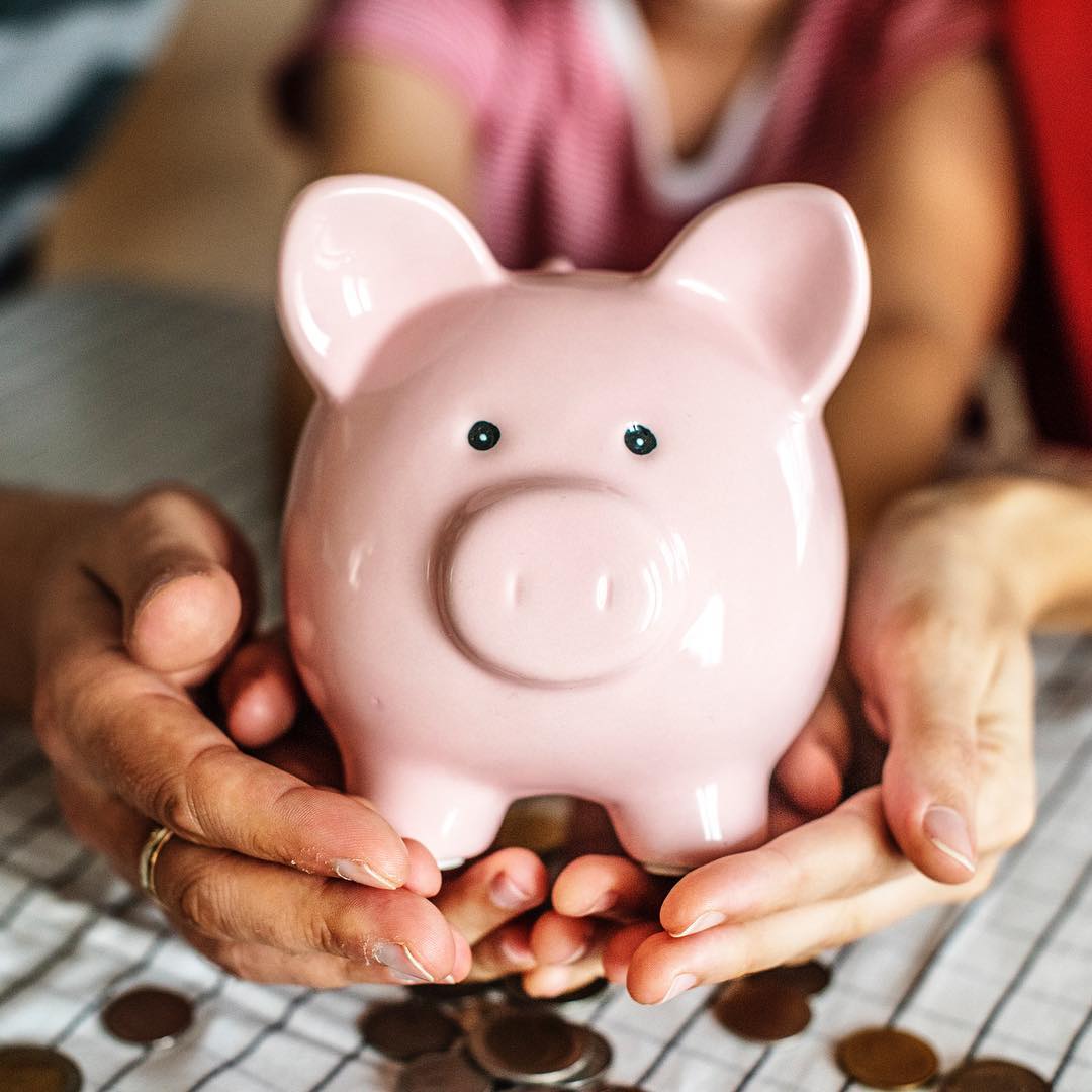 Couple's Hands Holding Pink Piggy Bank. Photo by Instagram user @japharmainc