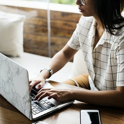 Woman Using Laptop at Desk. Photo by Instagram user @brandalchemysocial