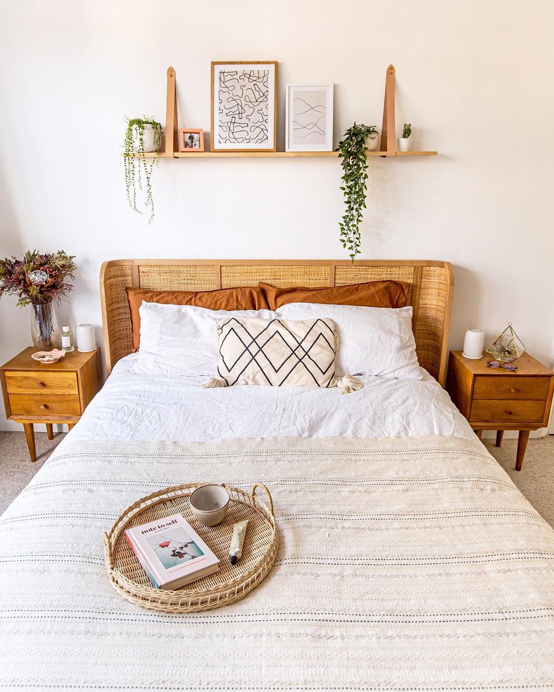 Bedroom with wicker headboard. Photo by Instagram user @homewithkelsey