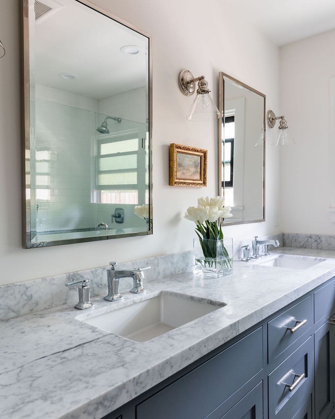 His and hers sinks in bathroom with small decorative accents. Photo by Instagram user @blairdesignandinteriors