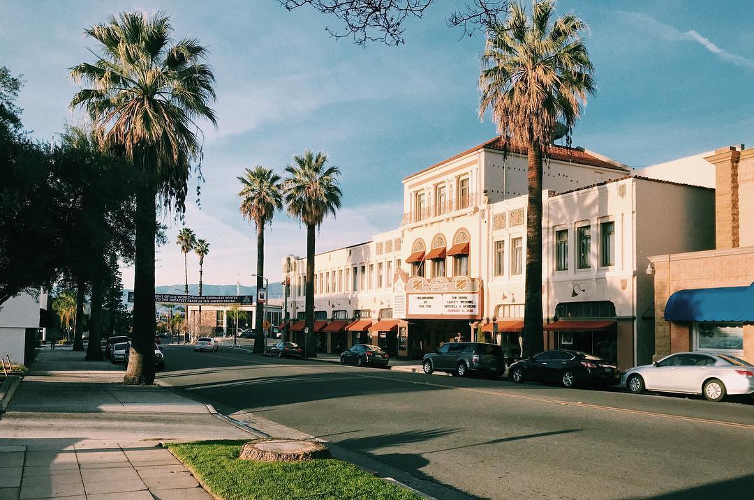 Movie theater between palm trees in Redlands, CA. Photo by Instagram user @ericwhedbee