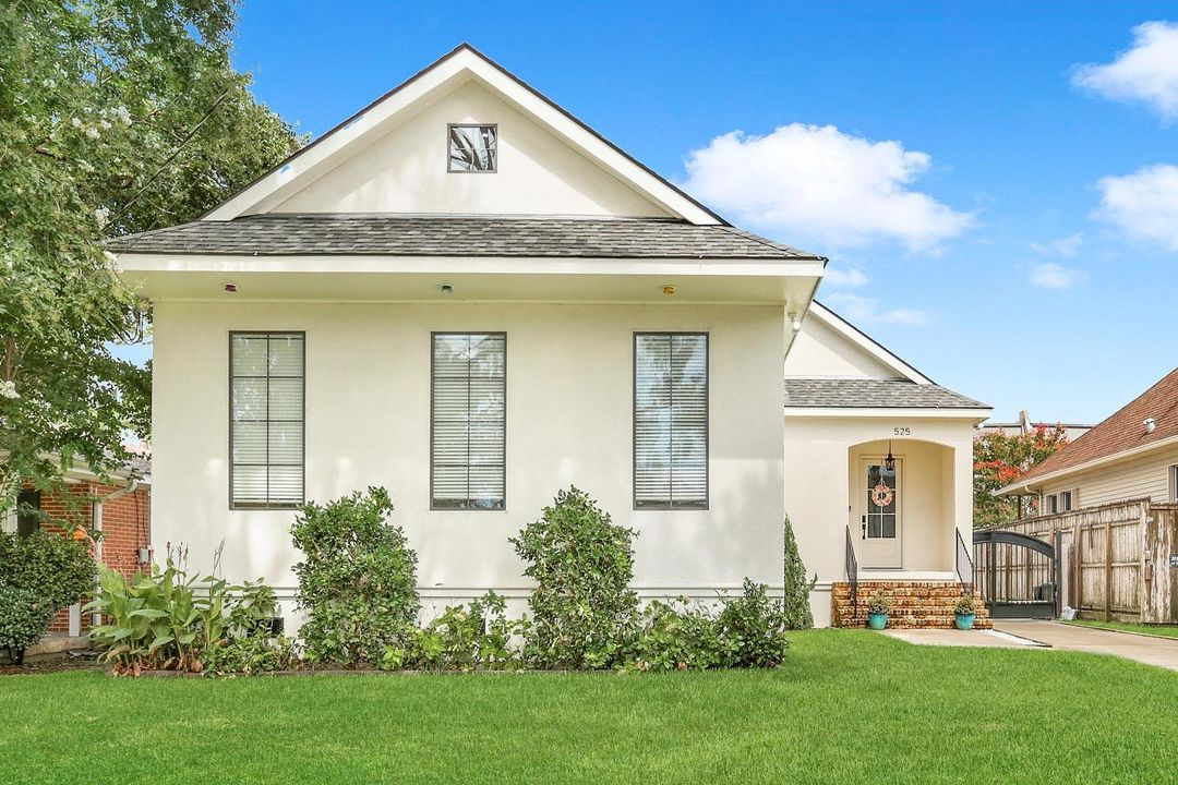 A white, single-story home with a neat, green yard in the Gentilly Terrace neighborhood of New Orleans. Photo by Instagram user @neworleansluxuryrealestate_a