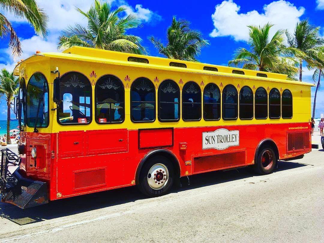 Red and Yellow Public Trolley on Fort Lauderdale Beach. Photo by Instagram user @adventures.of.jason.fll