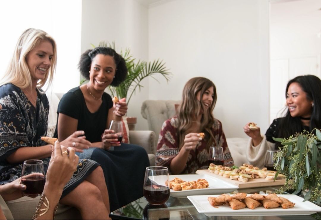Group of Friends Eating and Drinking Wine Around the Coffee Table at Home. Photo by Instagram user @kaftanlife