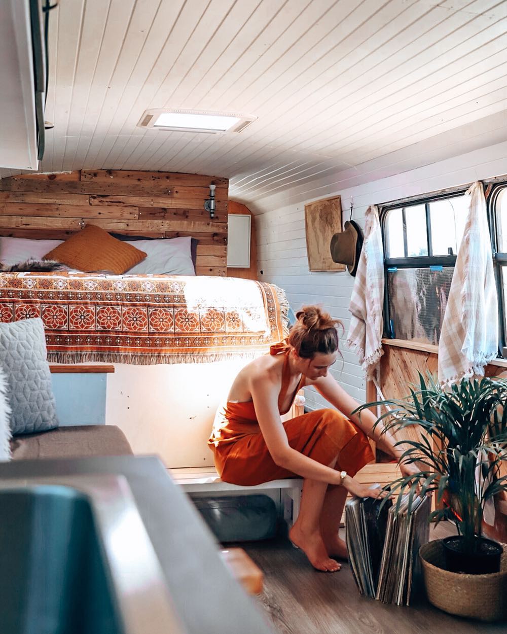 Woman Looking at Different Carpet Samples While Sitting in Her Tiny Home. Photo by Instagram user @gooseandellen