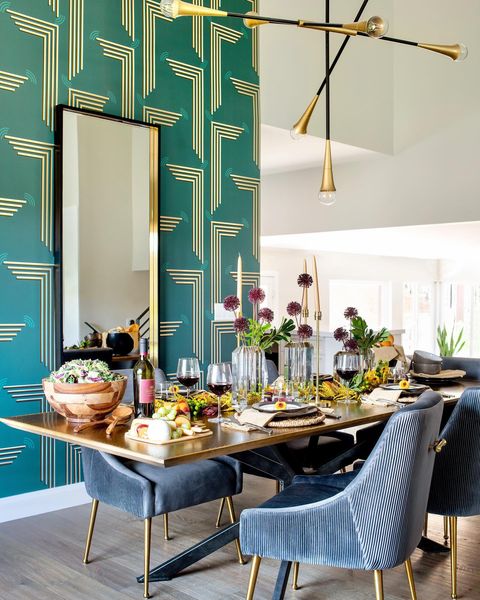 Modern dining room with unique wallpaper and a large mirror next to a big table. Photo by instagram user @johnmcclaindesign
