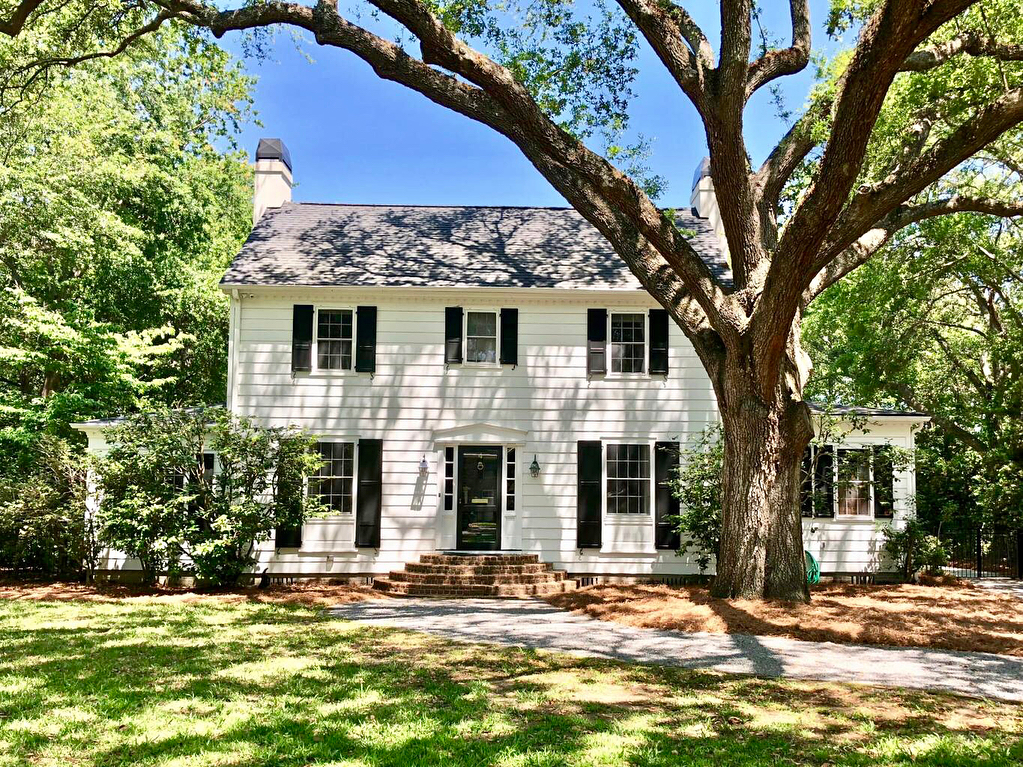 Front of white two-story home with large tree in front yard. Photo by Instagram user @beachresidential
