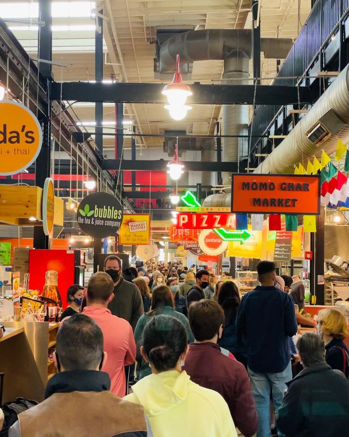A crowd of people gathering strolling amongst food vendors Columbus' North Market. Photo by Instagram user @wandering_missmeliss