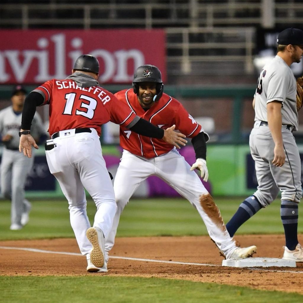 Two members of the Albuquerque Isotopes about to high-five. 