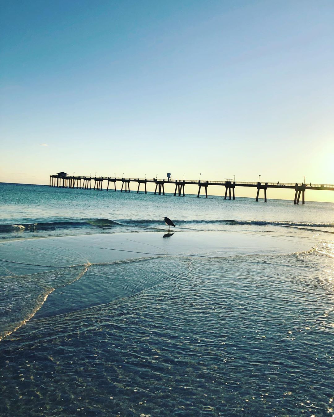 view of the ocean and fort walton beach pier photo by Instagram user @emeraldcoasthappenings