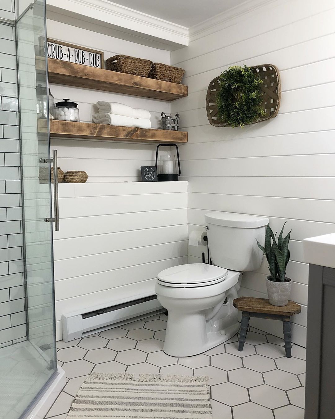 Bathroom with Towels, Baskets, and Jars on Wall Storage. Photo by Instagram user @vintagewhiteoak