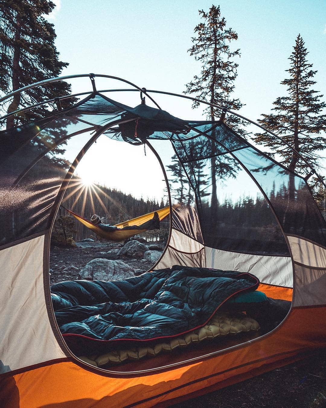 Man in a Hammock While Camping in the Mountains. Photo by Instagram user @campingtravellers