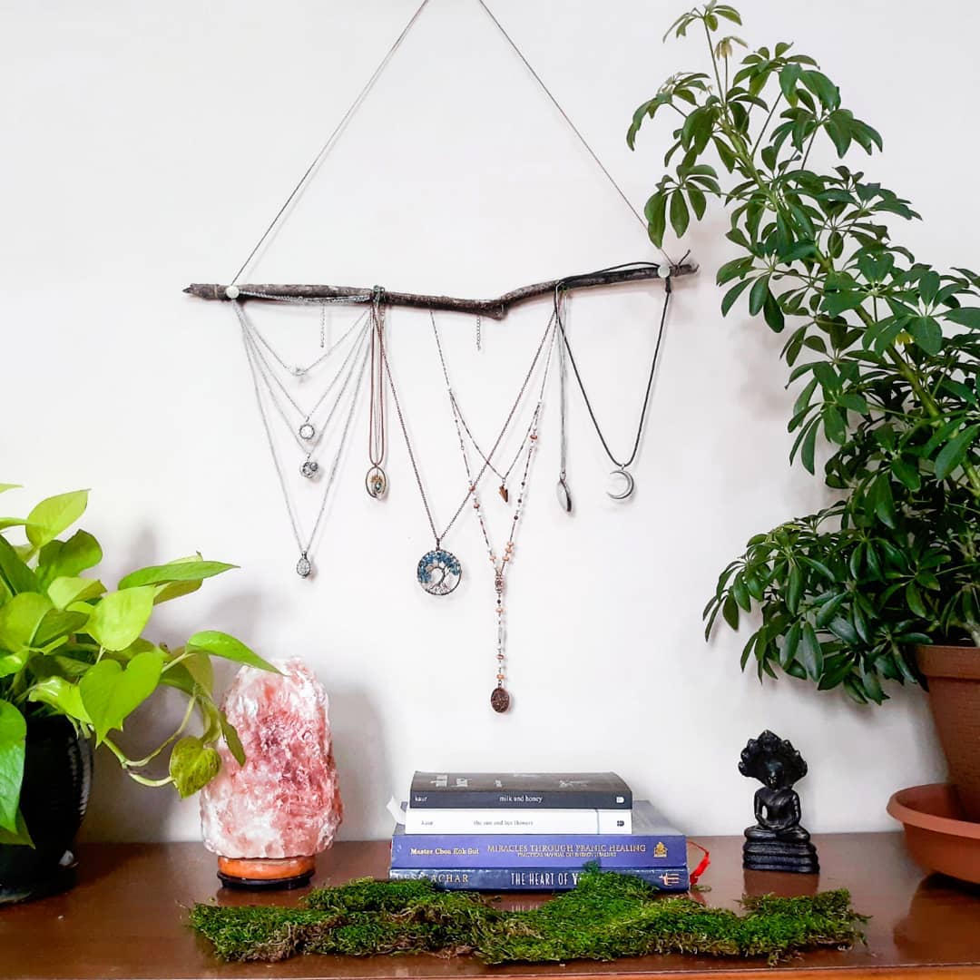 Jewelry Hanging from Hanger on Wall. Photo by Instagram user @mossminded