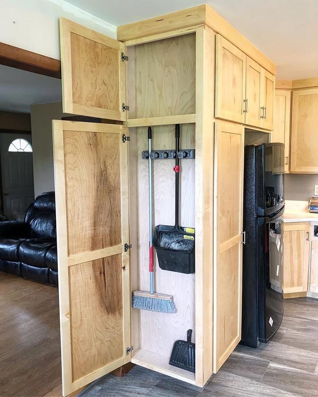 Hidden Storage Broom Closet in Kitchen. Photo by Instagram user @stewartscarpentryllc