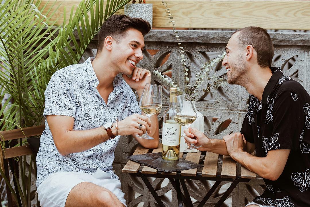 Couple Sharing Wine and a Meal at a Restaurant. Photo by Instagram user @alexandmike