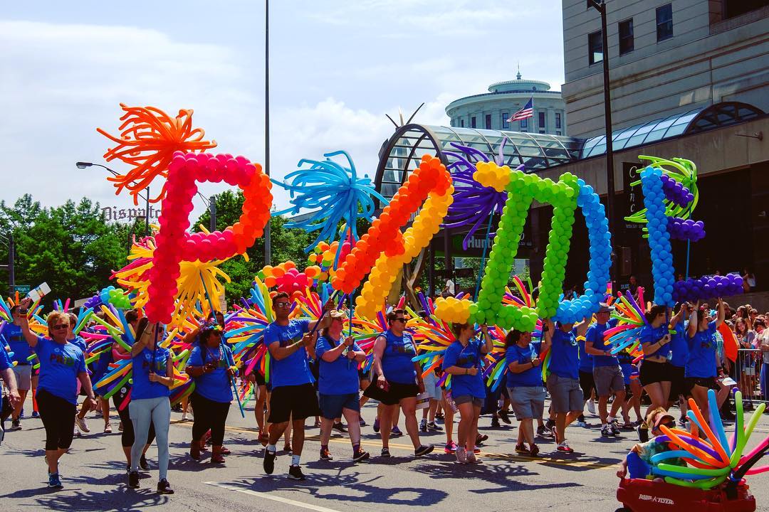 People holding balloons that spell PRIDE during a parade. Photo by Instagram user @yayitsm4tt