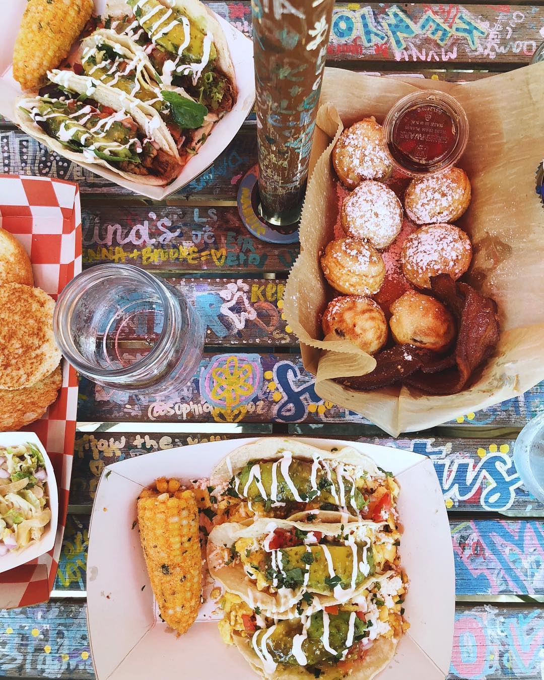 Overhead view of tacos, corn, and more on a table. Photo by Instagram user @katalinascafe