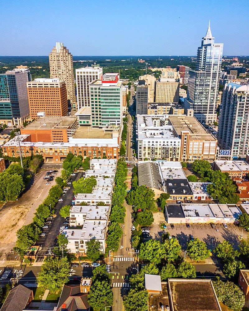 A skyline view of Raleigh featuring trees and several skyscrapers. Photo by Instagram user @thisisraleigh.