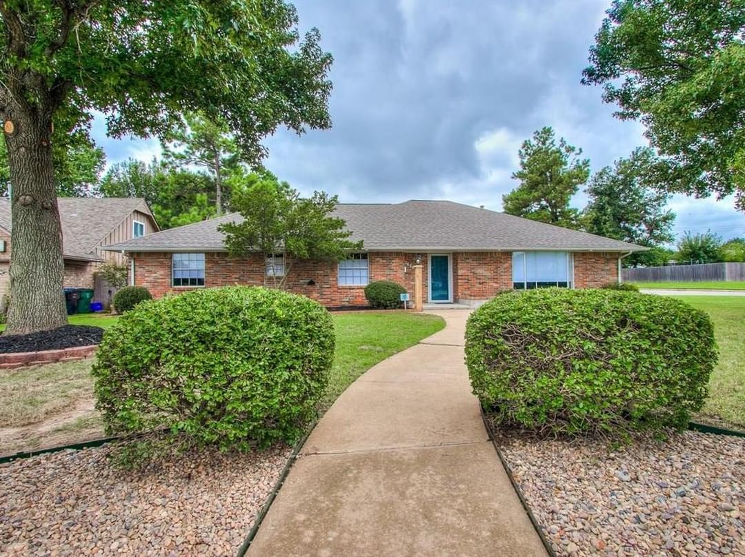 Beautiful ranch style home with red and beige brick and long sidewalk leading to front door. Photo by Instagram user @okcrealestateshow