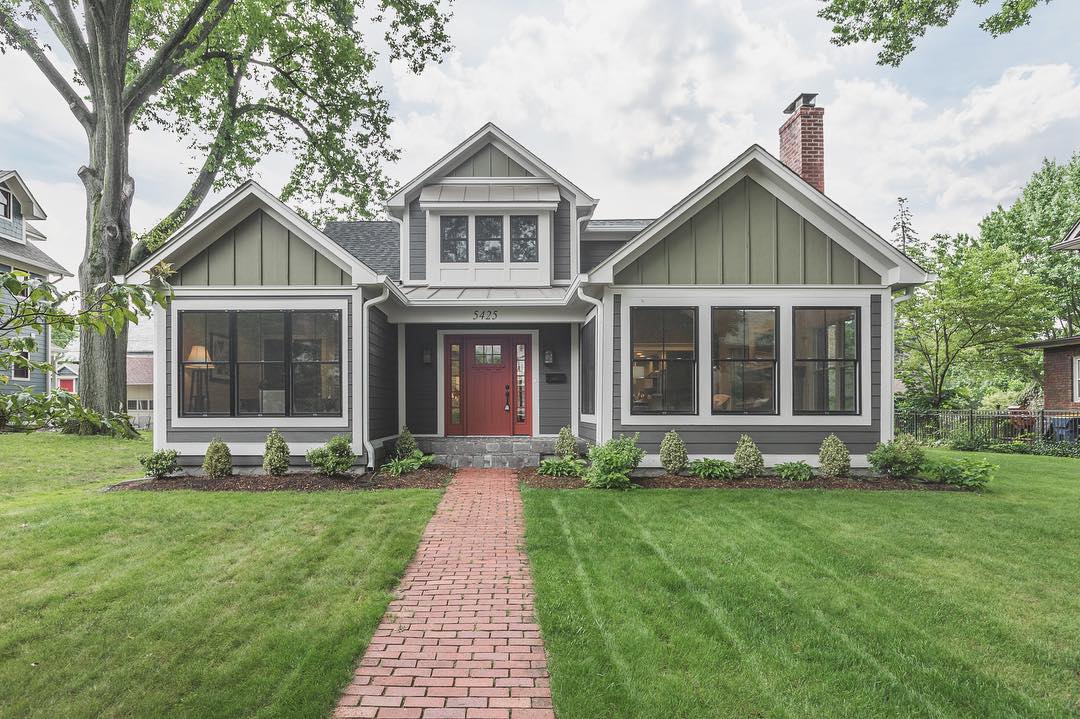 Front of single-family home with gray paint and white trim and a red brick footpath Photo by Instagram user @mikefeldman_realtor