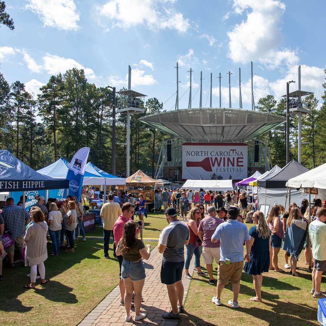 People walking between tents at the NC Wine Festival in Raleigh. Photo by Instagram user @ncwine.