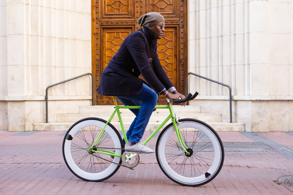 Man riding a green bike