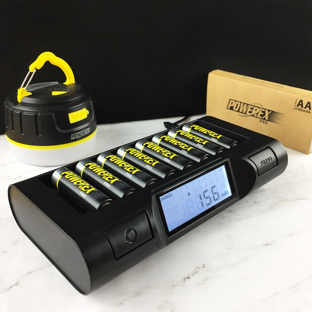 PowerEx Pro black battery port charging 8 AA batteries on white marble countertop. Photo from Instagram user @mahaenergy