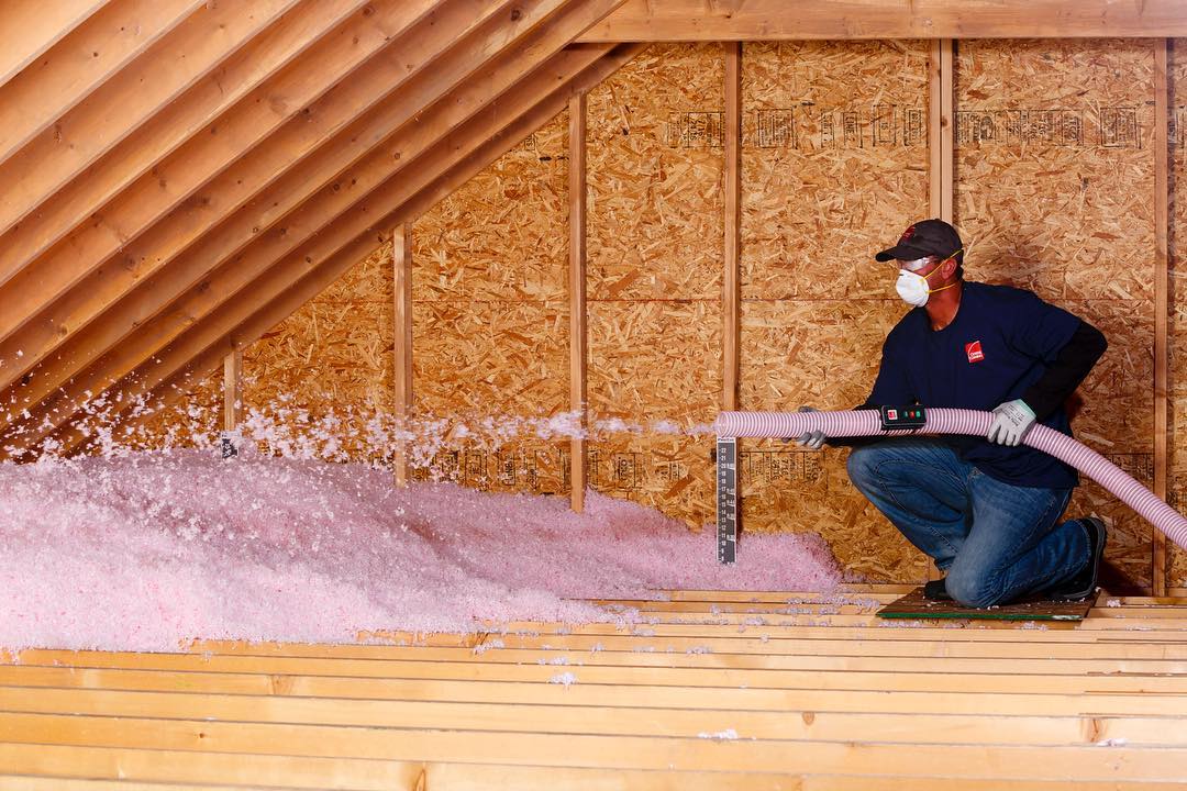 Man adding insulation in home attic. Photo by Instagram user @garciadidmyroof