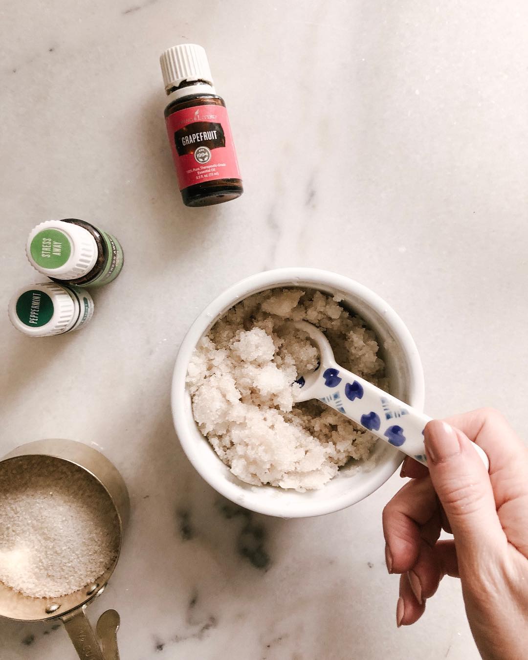 Woman making homemade sugar scrub. Photo by Instagram user @dwellwellcollective
