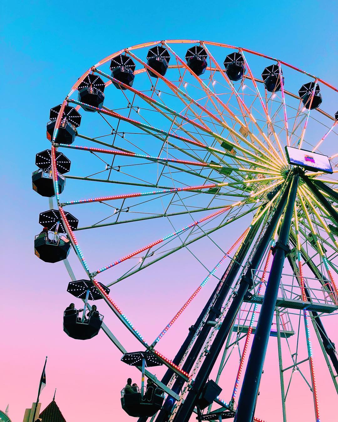 View from under large ferris wheel at dusk at North Carolina State Fair. Photo by Instagram user @sophienelise