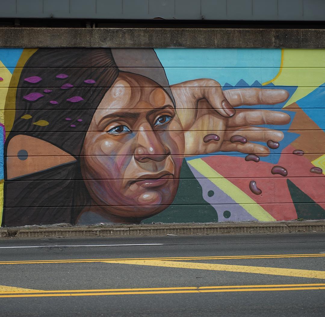 Colorful wall mural on the outside of a building at Newark Penn Station. Photo by Instagram user @halopigg