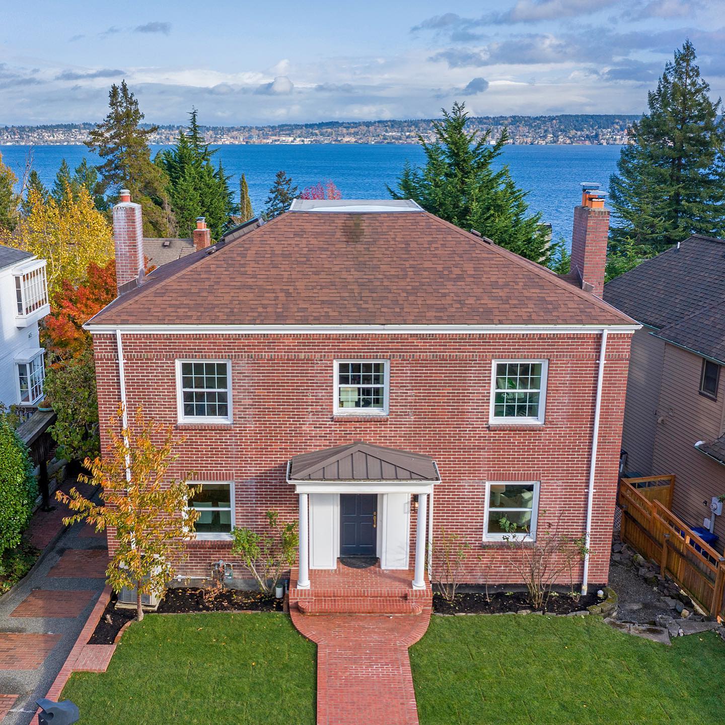 aerial shot of brick house with green lawn