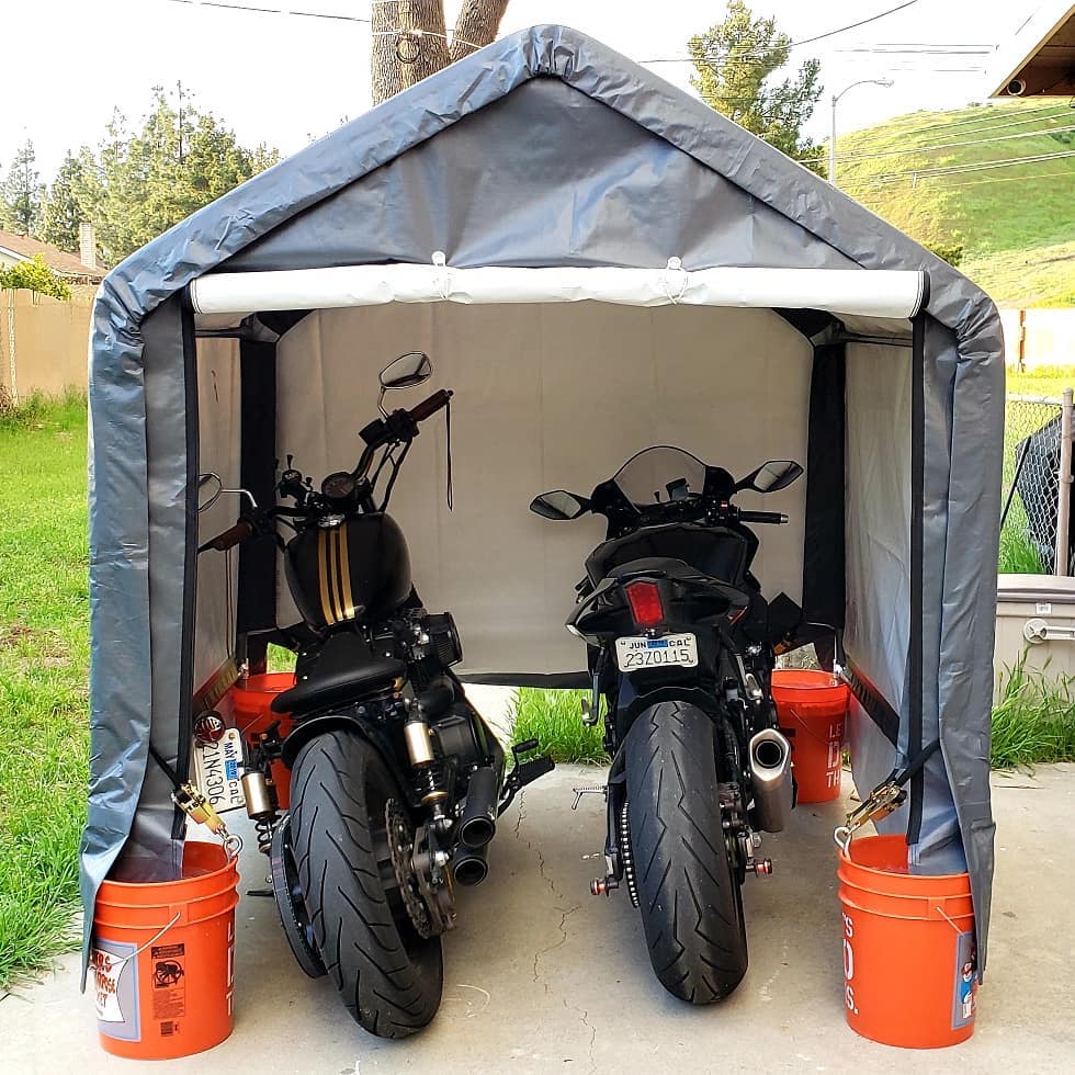 two motorcycles being stored inside of an at home shelter photo by Instagram user @meli_matic