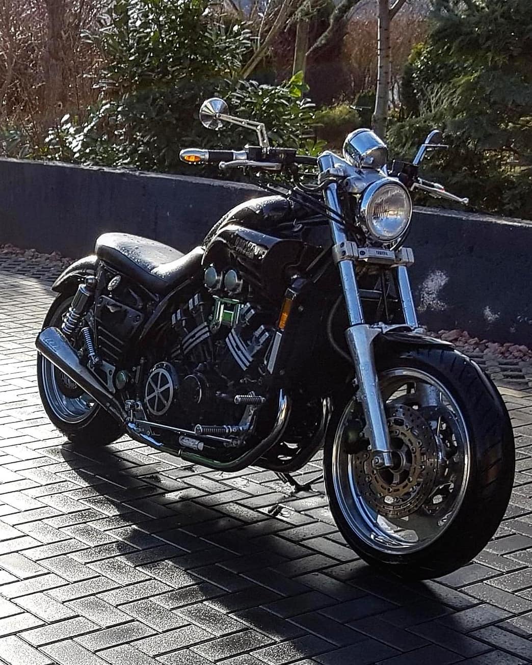 black motorcycle being kept in a driveway photo by Instagram user @yamaha.vmax.1200.only