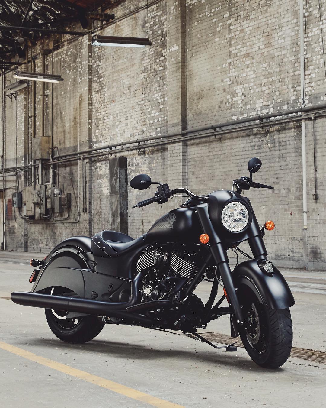 matte black cruiser motorcycle parked on the road photo by Instagram user @indianmotorcycle