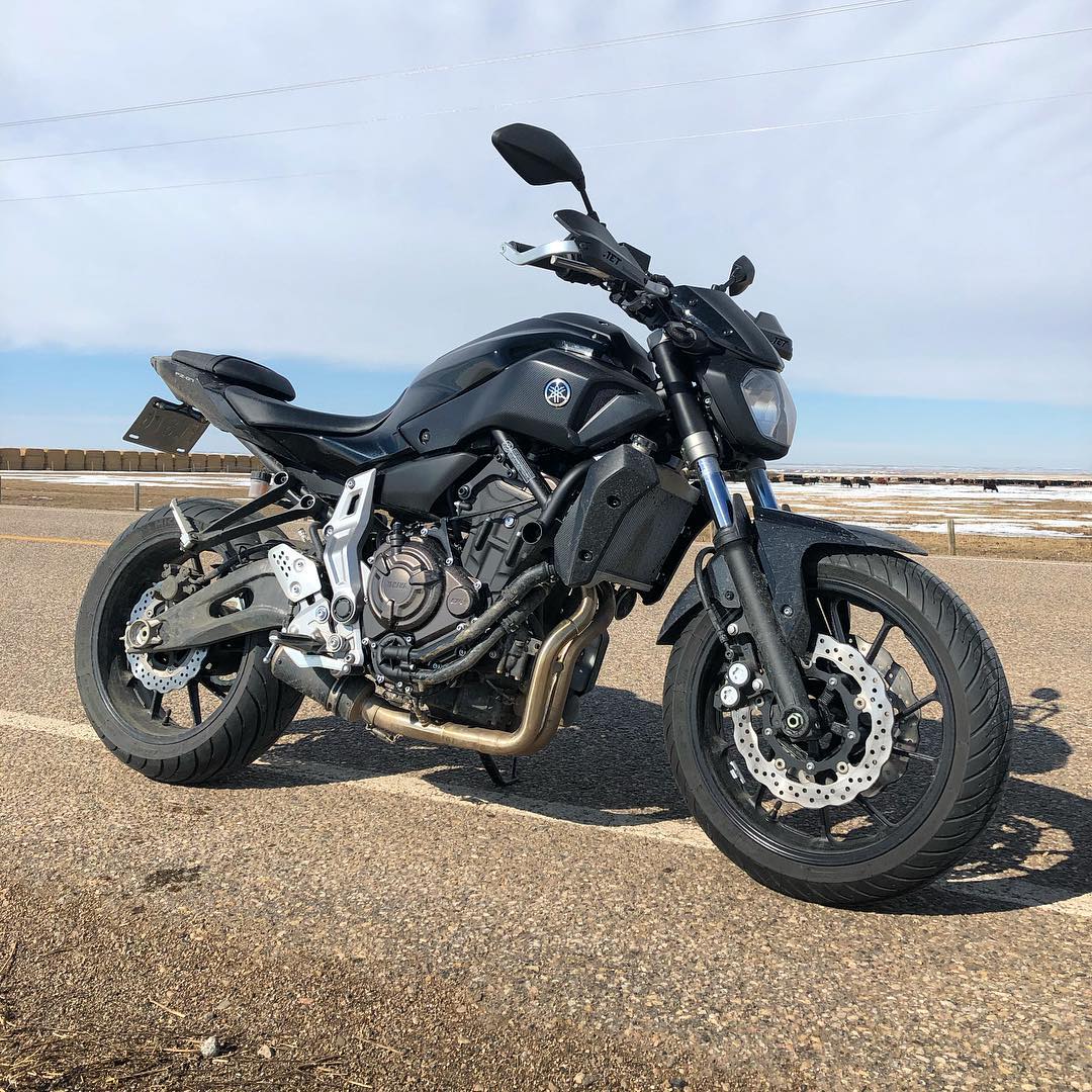 black standard motorcycle parked on the road photo by Instagram user @advriley