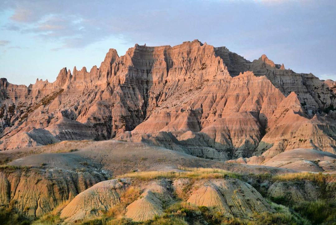 Red canyons in the Badlands during sunset. Photo by Instagram user @badlandsnps