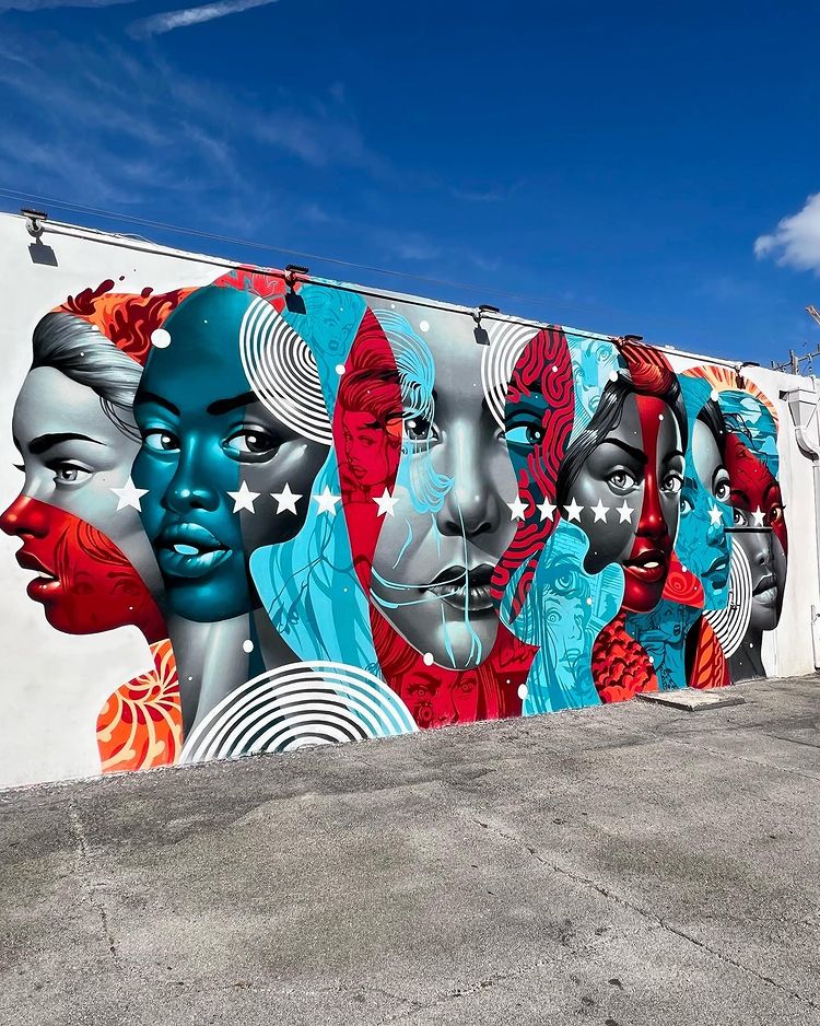 Black, white, red, and blue mural of multiple faces. Photo by Instagram user @dressedtothej9s