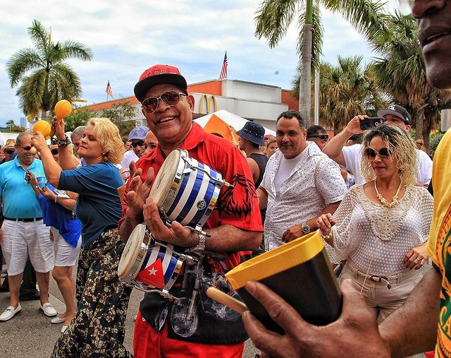 Crowd dancing and laughing while man plays bongos. Photo by Instagram user @thinkmagfl