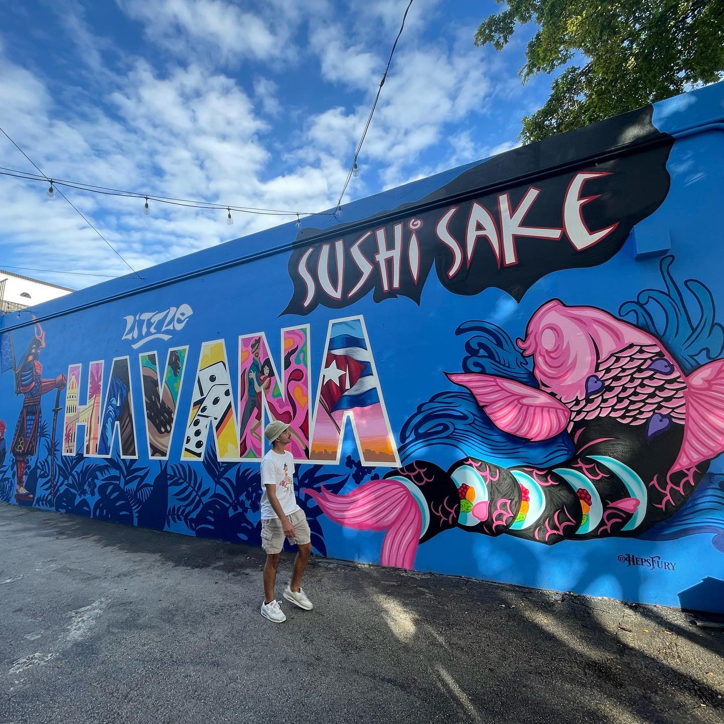 Man walking beside Havana mural in Little Havana. Photo by Instagram user @abalsumaiit