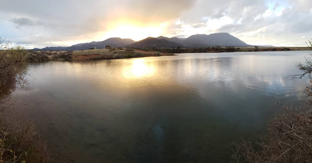 Lake view with mountains in the back at Fort Carson, CO. Photo by Instagram user @soluda_
