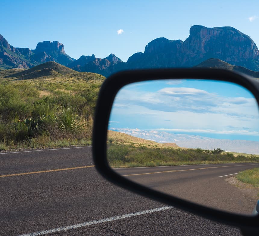 Mountains in a review mirror. Photo by Instagram user @squintphoto