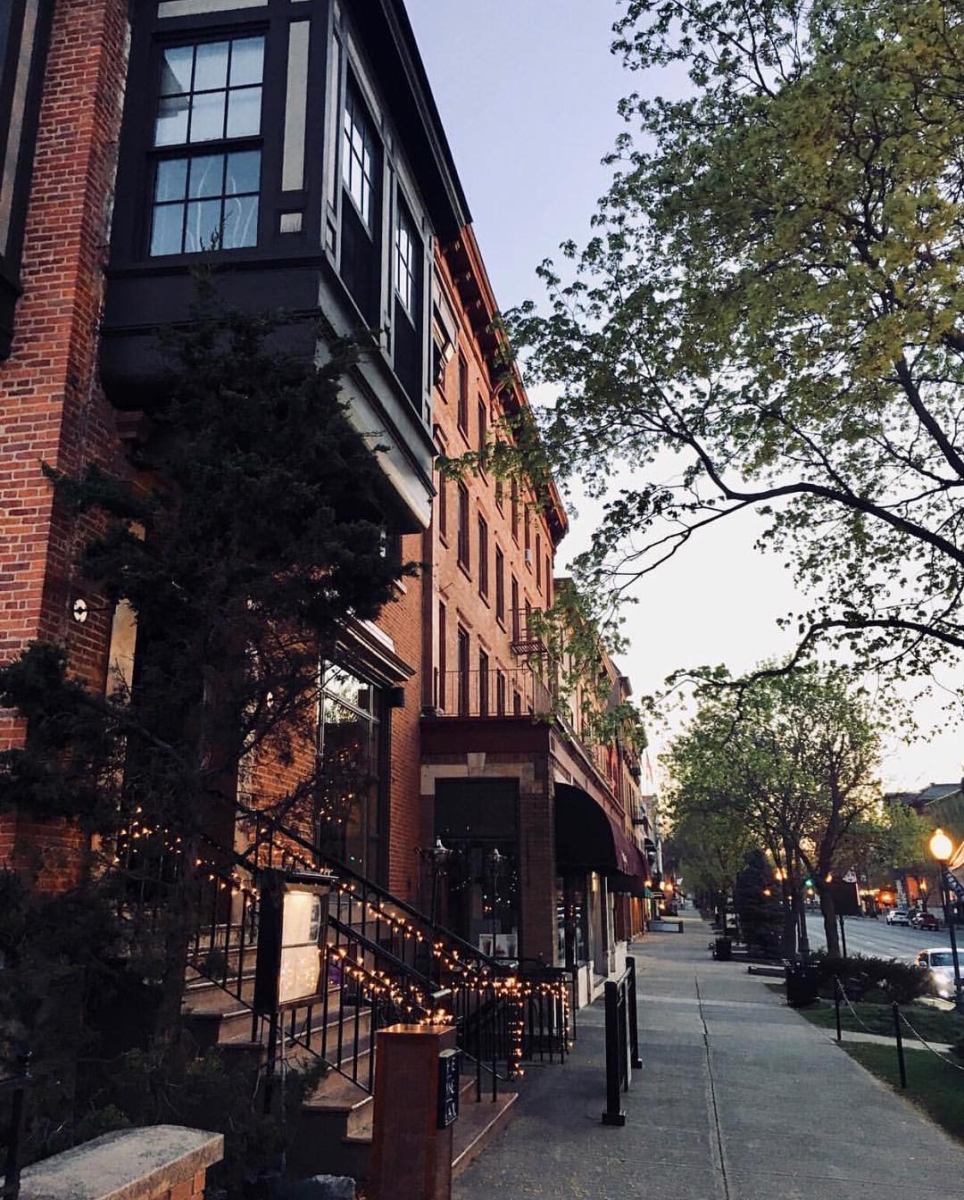 Brick building with twinkle lights on Broadway Street in Saratoga Springs. Photo by Instagram user @kelley_beth_