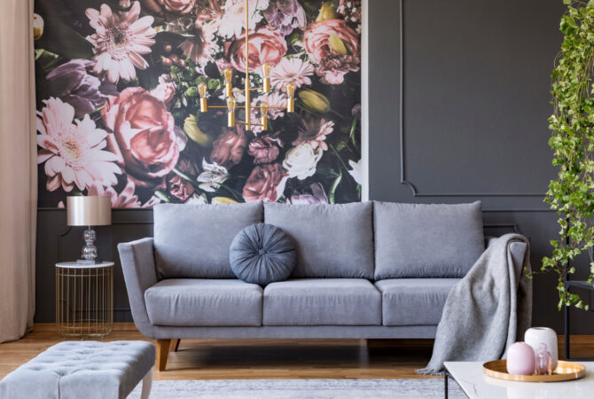 Dark gray living room with a light gray couch and pink floral accent wall
