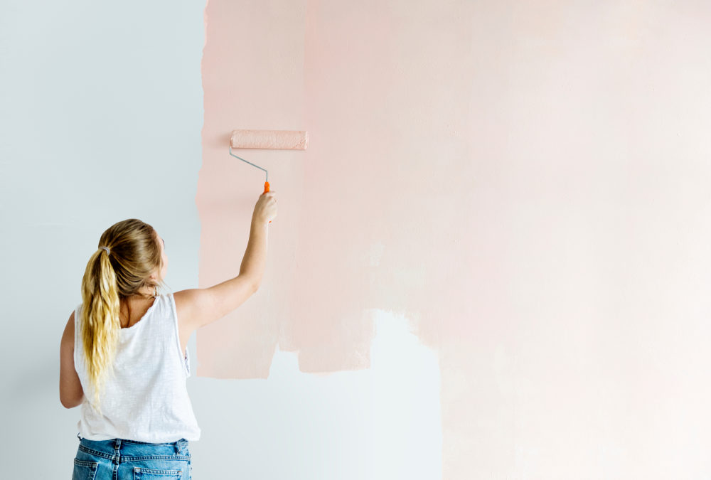Girl painting her wall in blush pink