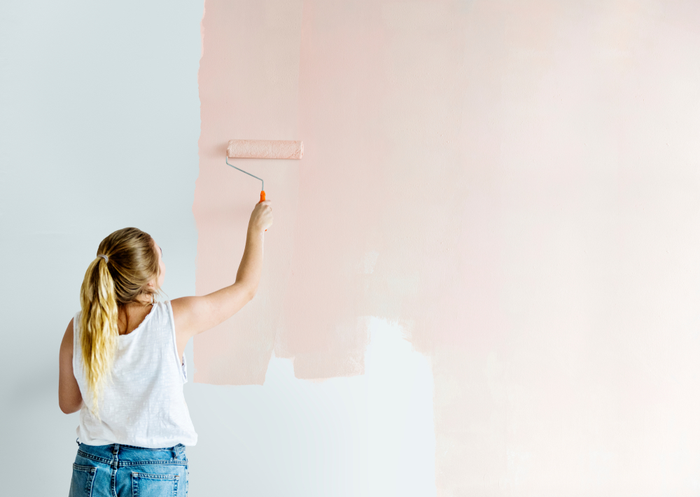 Girl painting her wall in blush pink