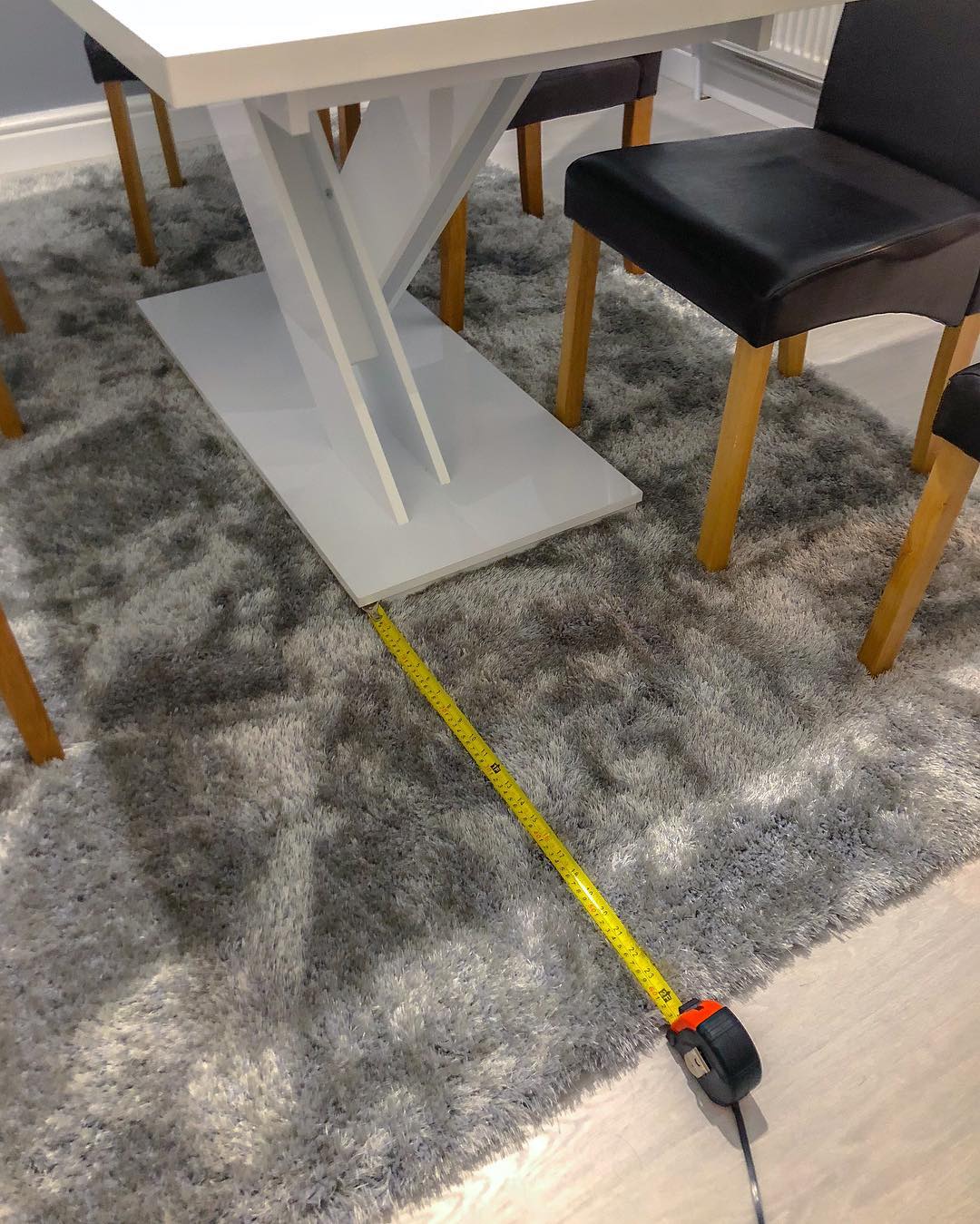 Measuring the distance between a table and carpet.