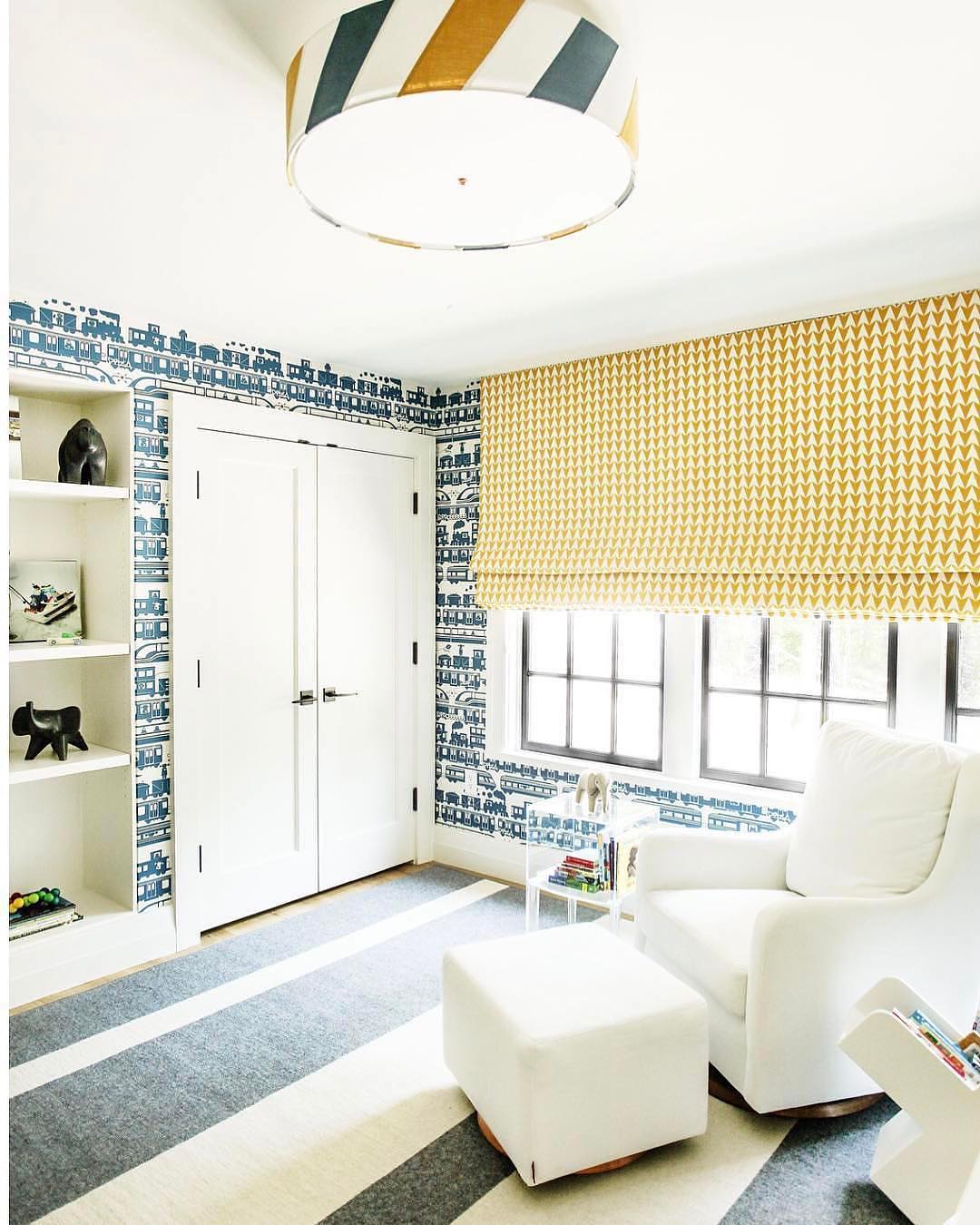 Living room with blue striped floors and blue patterned walls. Photo by Instagram user @carawoodhouseinteriors