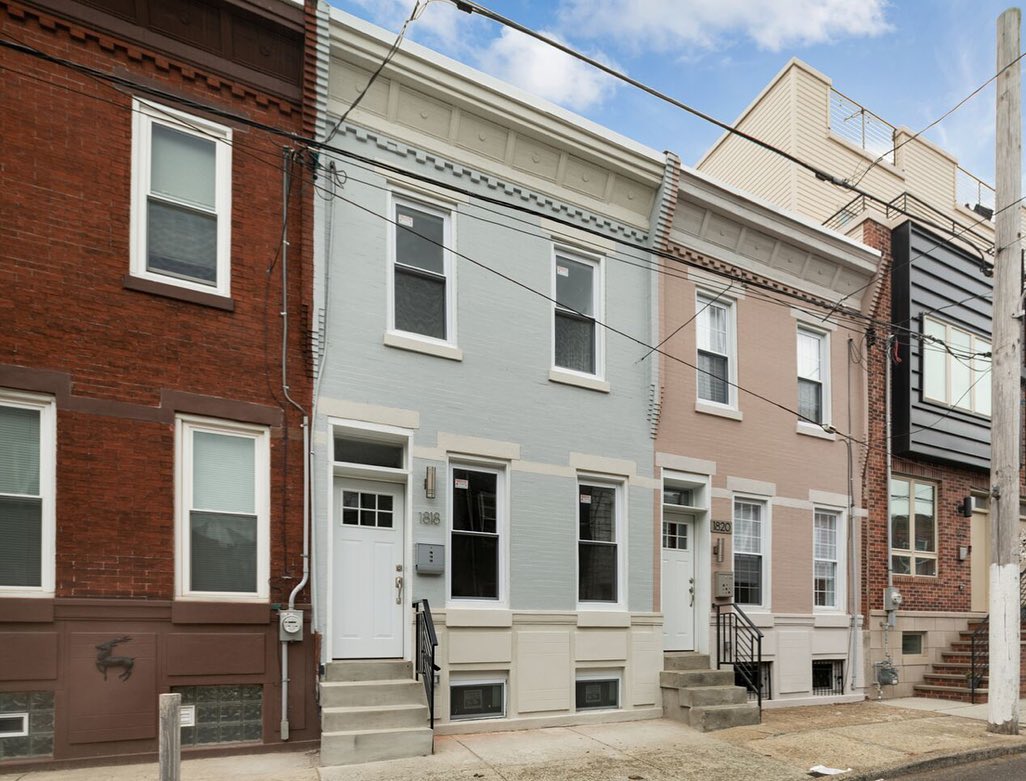 Brick and blue and pink rowhouses in Point Breeze, Philadelphia. Photo by Instagram user @advancephilly